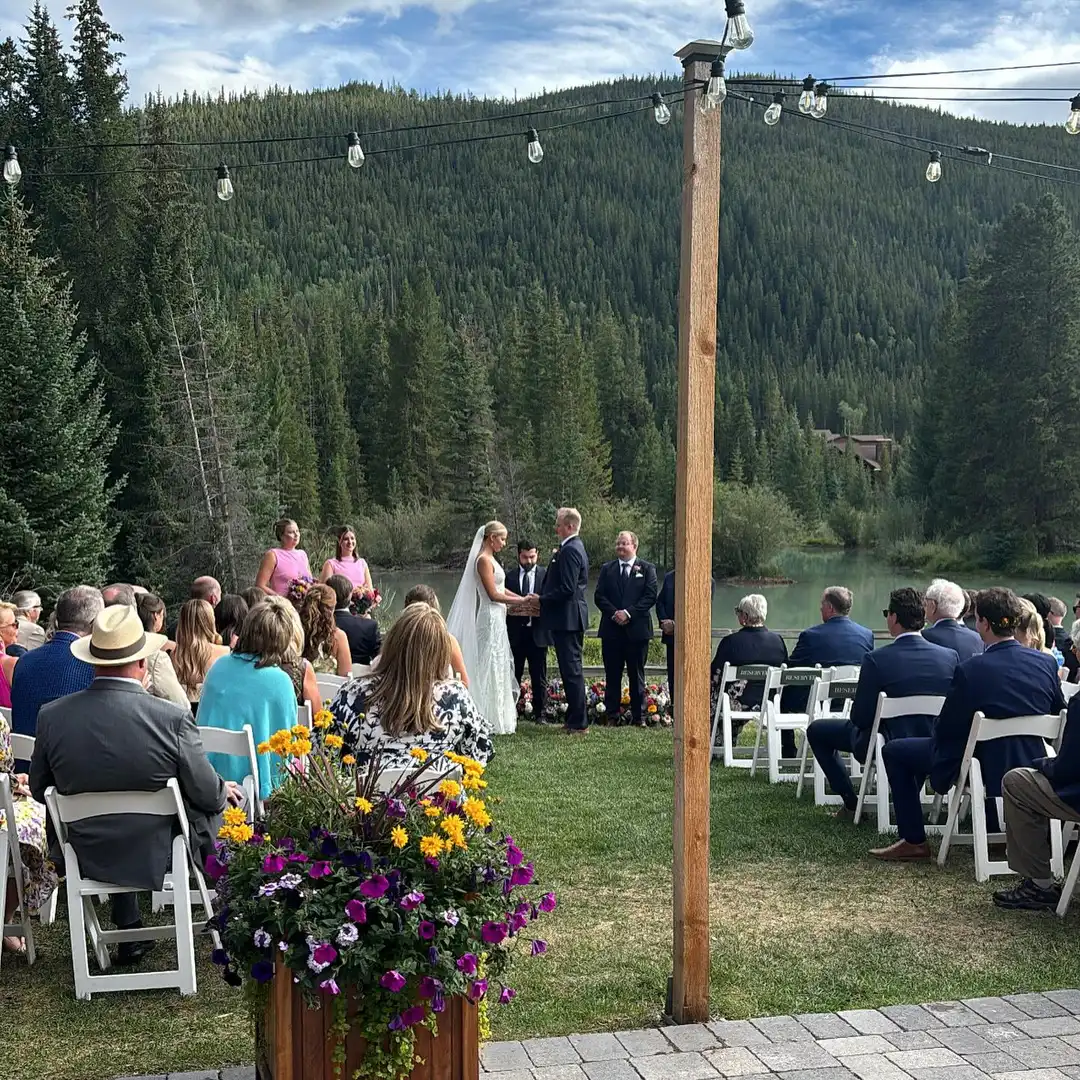 Forest wedding ceremony at Ski Tip Lodge, guests under string lights